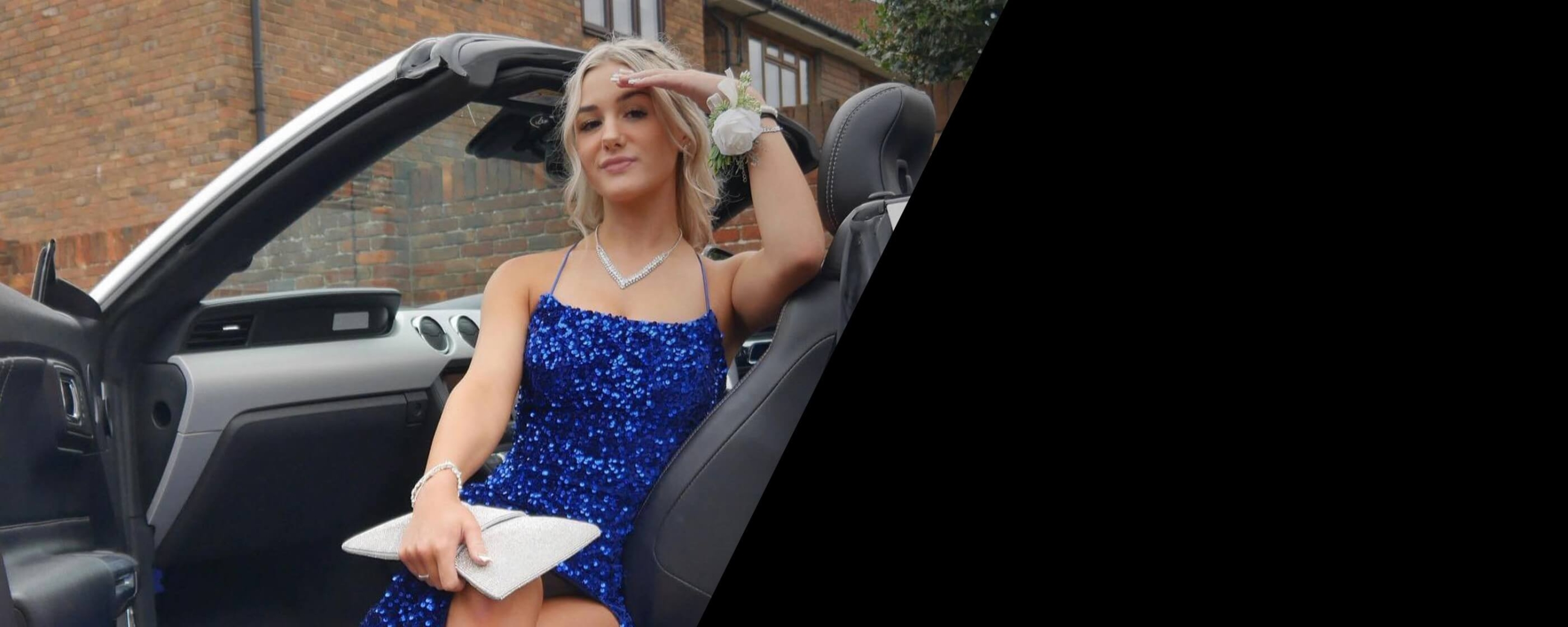 Model wearing a blue gown in the car